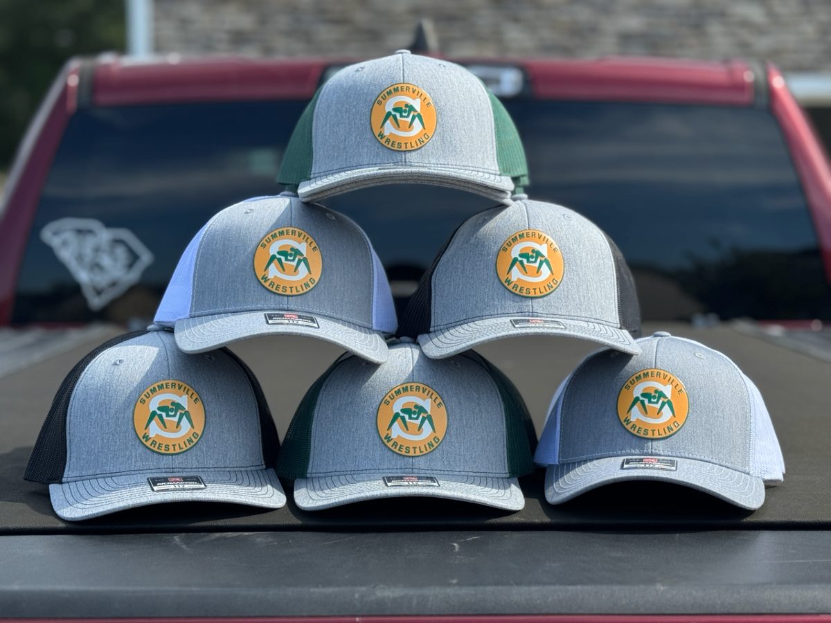 Stack of heather grey Richardson trucker caps with custom Summerville Wrestling patches