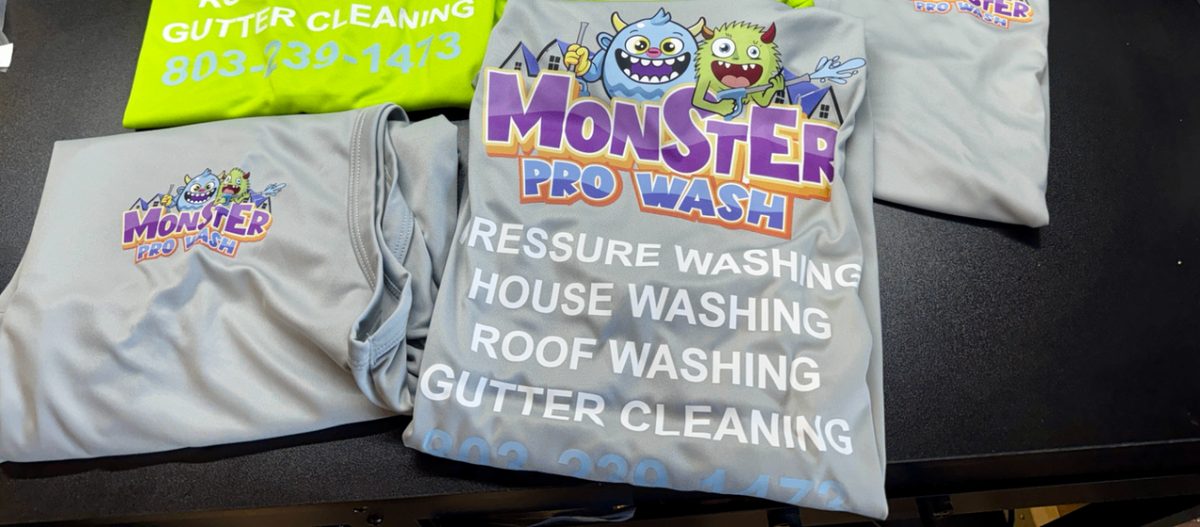 Grey performance polos and printed work shirts branded for Monster Pro Wash