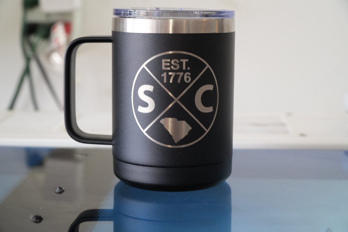 Black insulated camp mug laser engraved with an SC Est. 1776 crest
