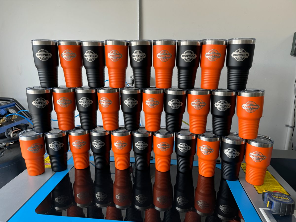 Rows of orange and black insulated tumblers laser engraved with a Contigo logo
